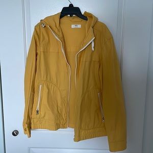 Bright yellow raincoat with hood and white detail